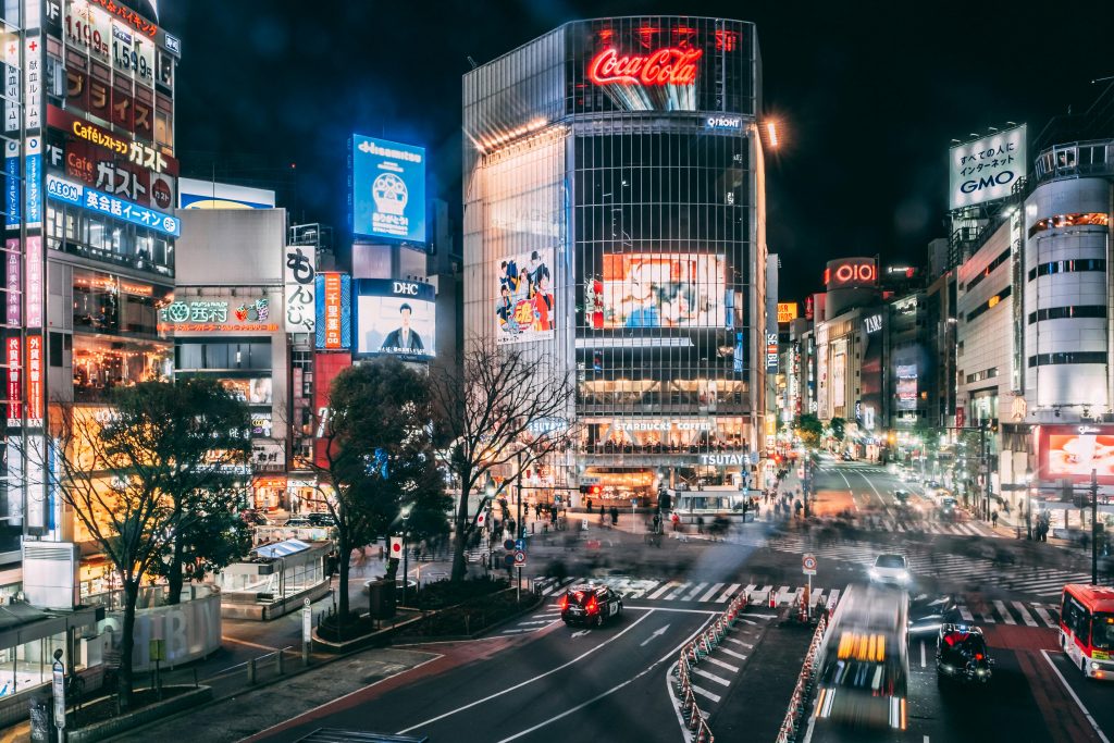 Spectacular scenery of various modern commercial buildings with colorful illumination located in Shibuya district of Tokyo at night